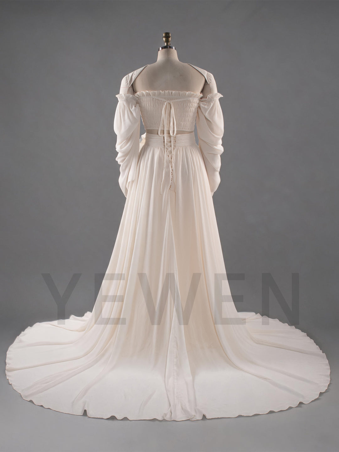 An off-the-shoulder white chiffon gown with a long train, displayed on a mannequin against a gray studio background.
