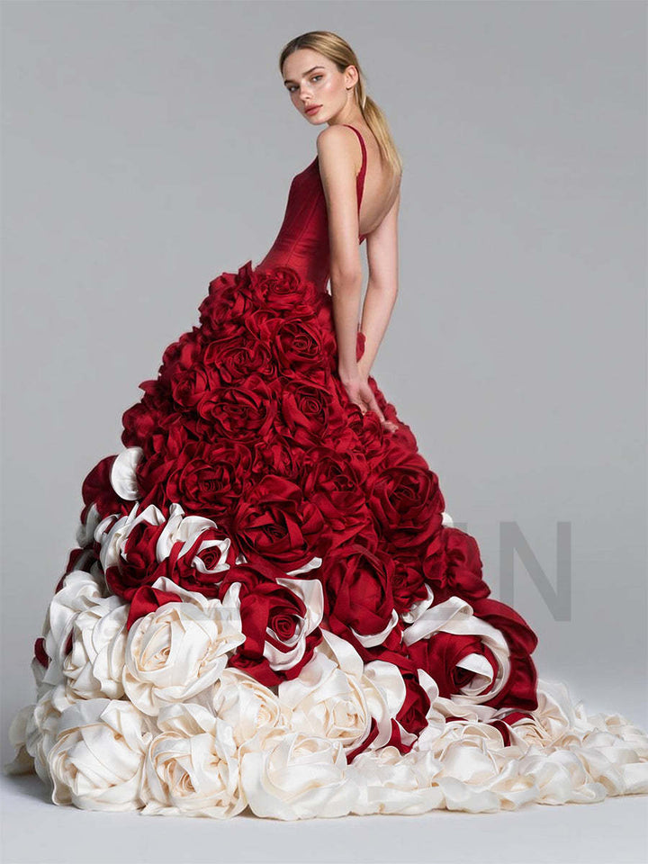 Back view of a model wearing a beautiful 3D floral red ball gown with a sweep train.