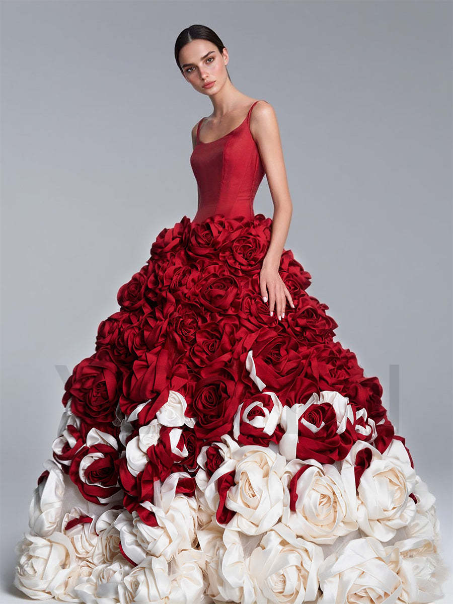 Side view of a model wearing a romantic 3D floral red ball gown showcasing the layered floral details.