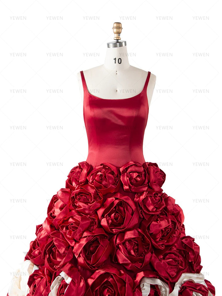 Close-up front view of a model wearing a 3D floral red ball gown highlighting the sweetheart neckline.