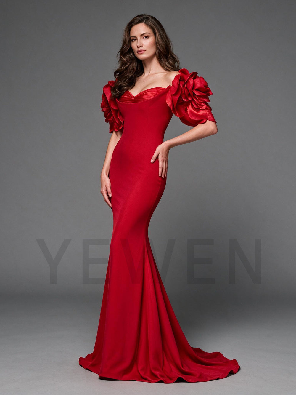 Side profile of a red mermaid evening gown with 3D floral off-shoulder sleeves.