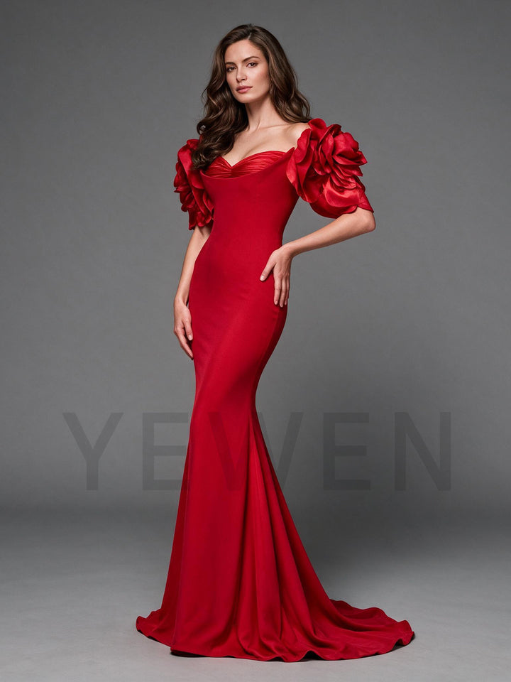 Side profile of a red mermaid evening gown with 3D floral off-shoulder sleeves.
