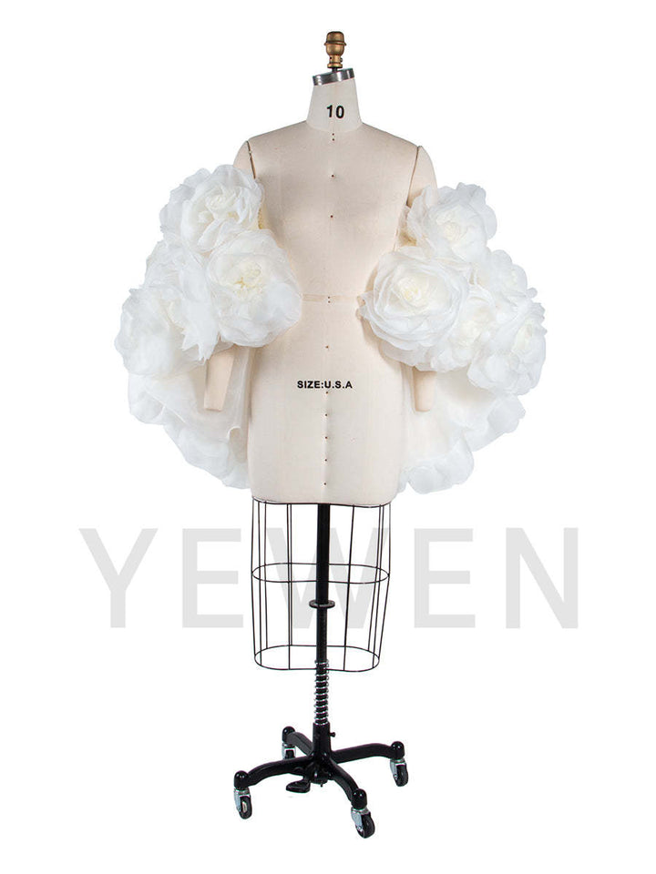 Side view of 3D flower cape for maternity photoshoot showing flowing elegant structure and floral design