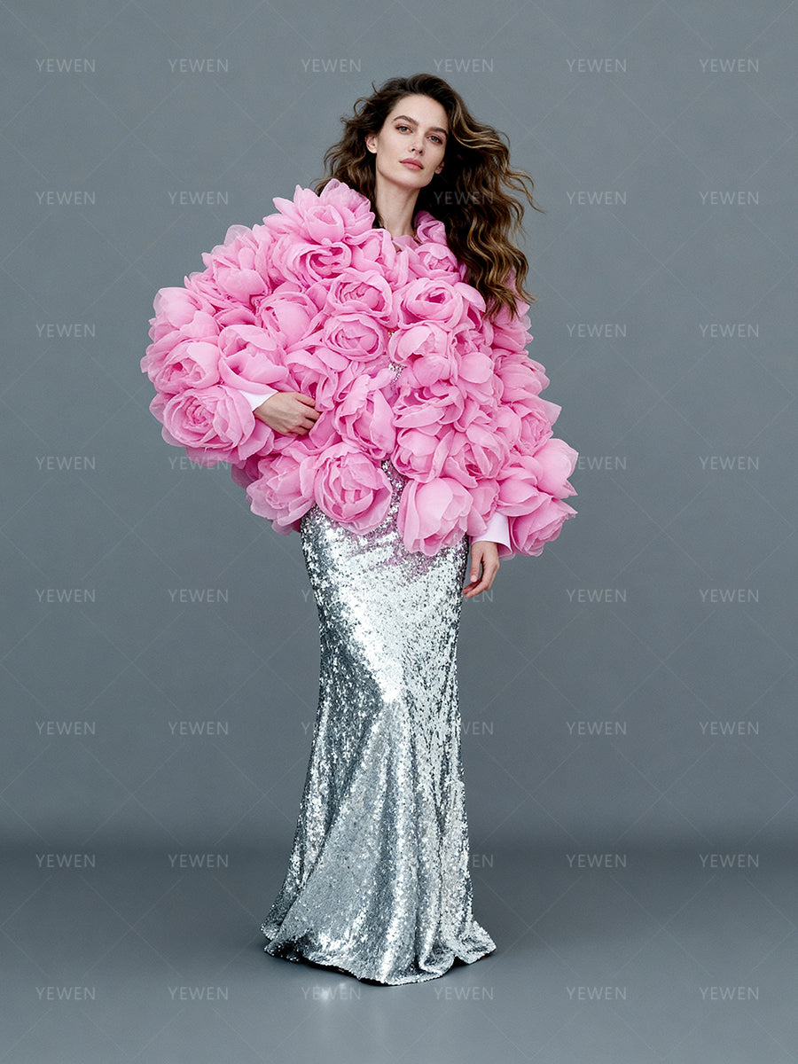 Bride wearing pink 3D flower outfit in studio wedding photography session with handmade floral jacket