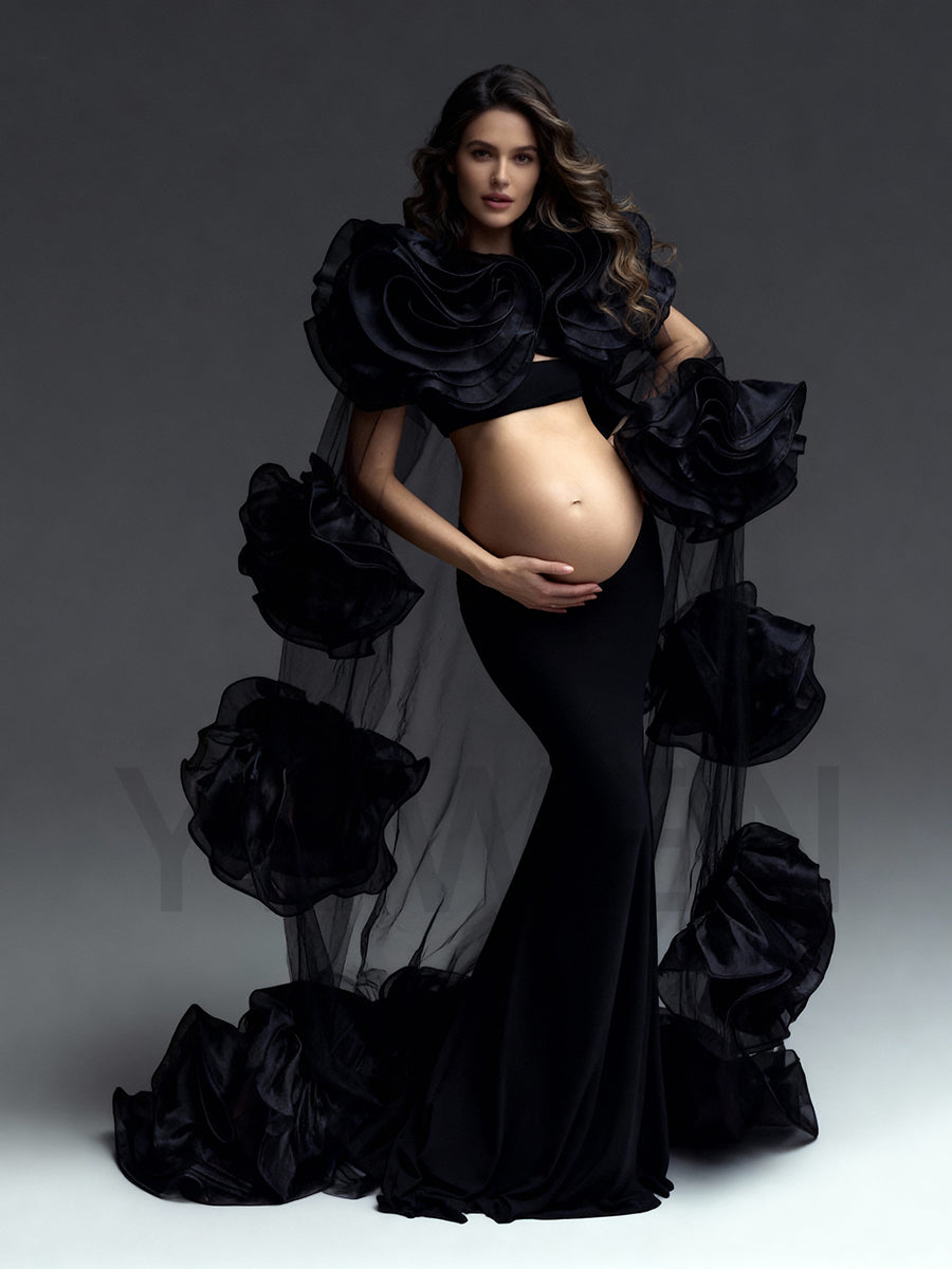 Pregnant woman wearing black baby shower dress 3 piece set in dramatic studio maternity photoshoot