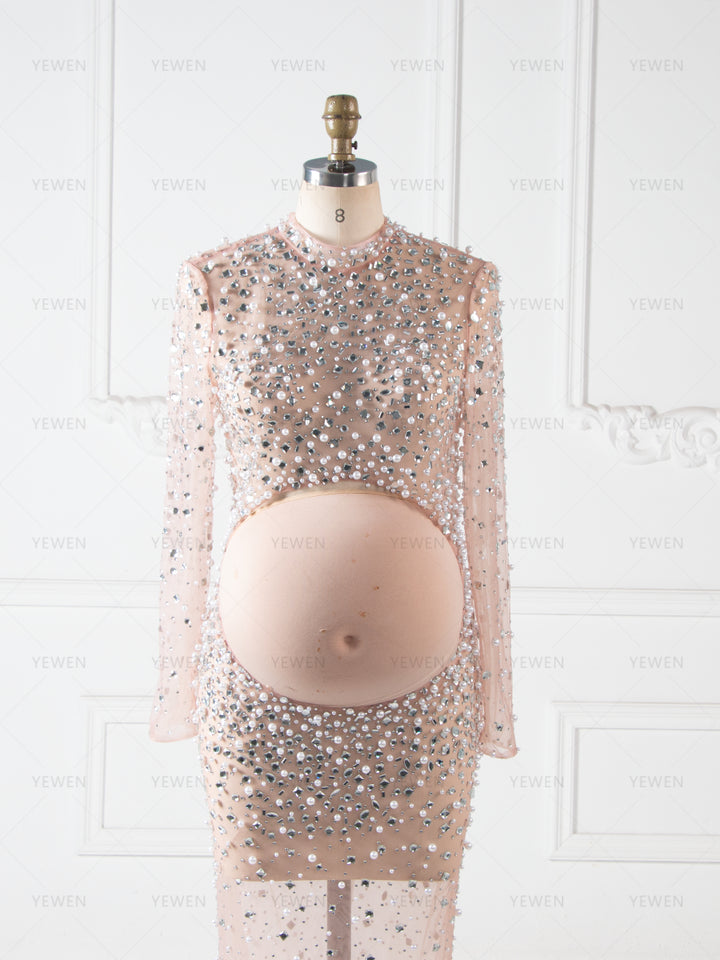 Close-up of pearl and rhinestone beadwork on maternity photoshoot dress showing luxury craftsmanship