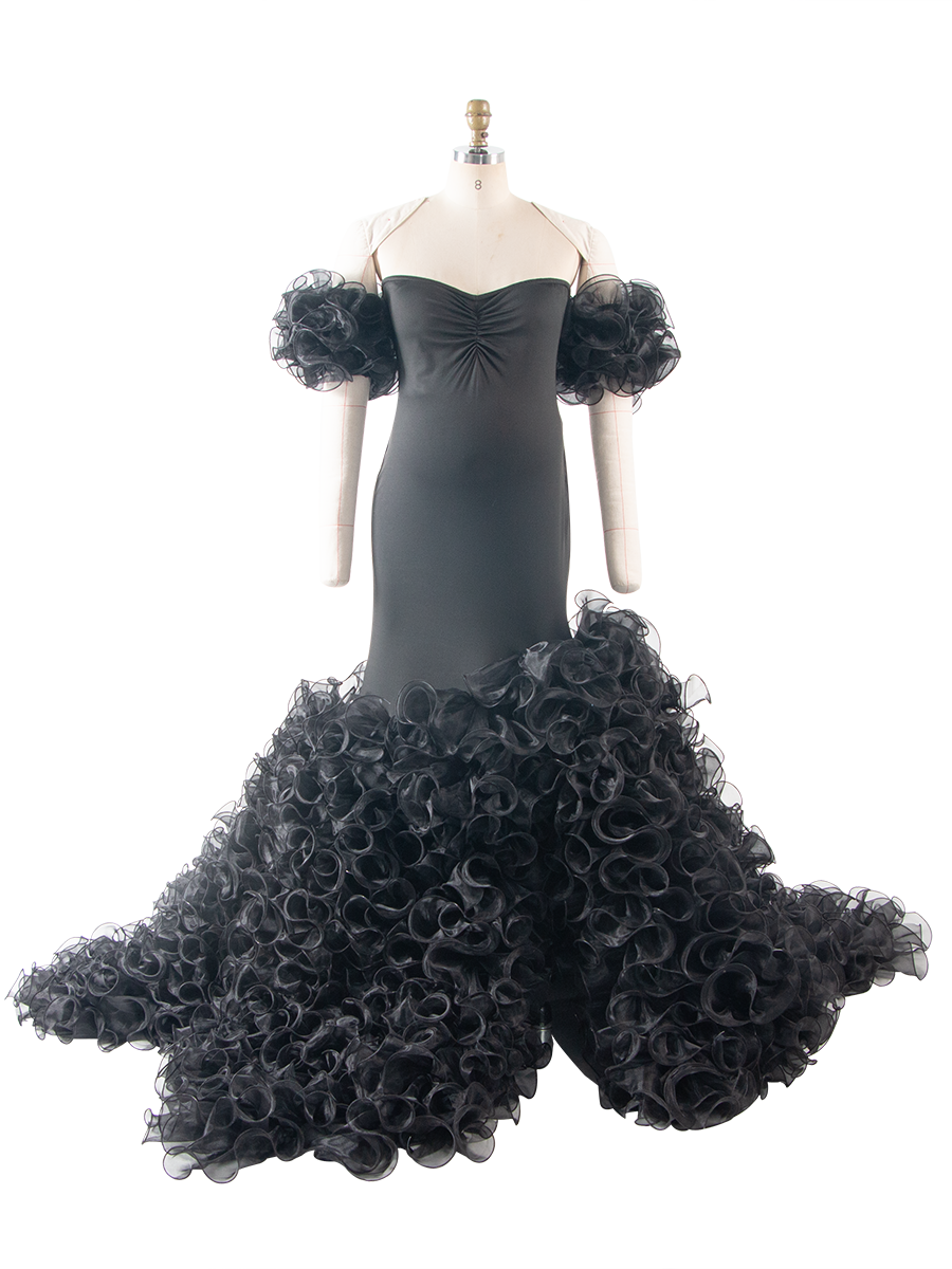 Front view of a black maternity gown for baby shower, featuring a strapless twisted bodice, off-shoulder puffed sleeves, and a dramatic layered ruffle skirt, displayed on a mannequin.