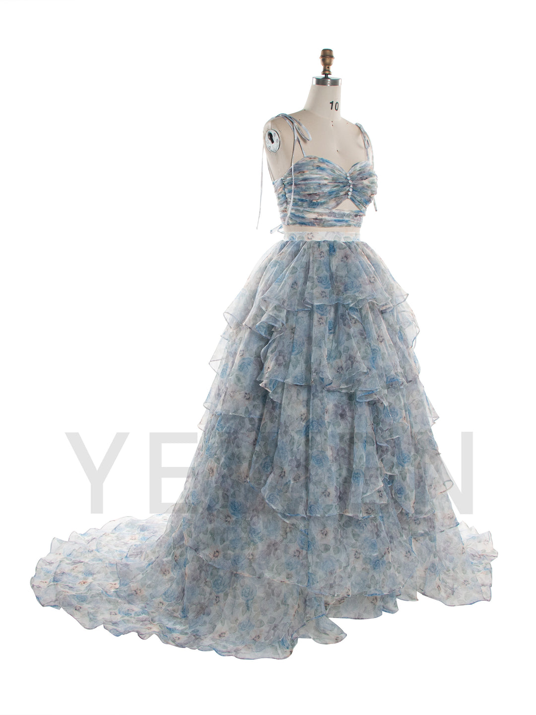 A light blue and white floral print formal gown displayed on a dress form mannequin against a white background.