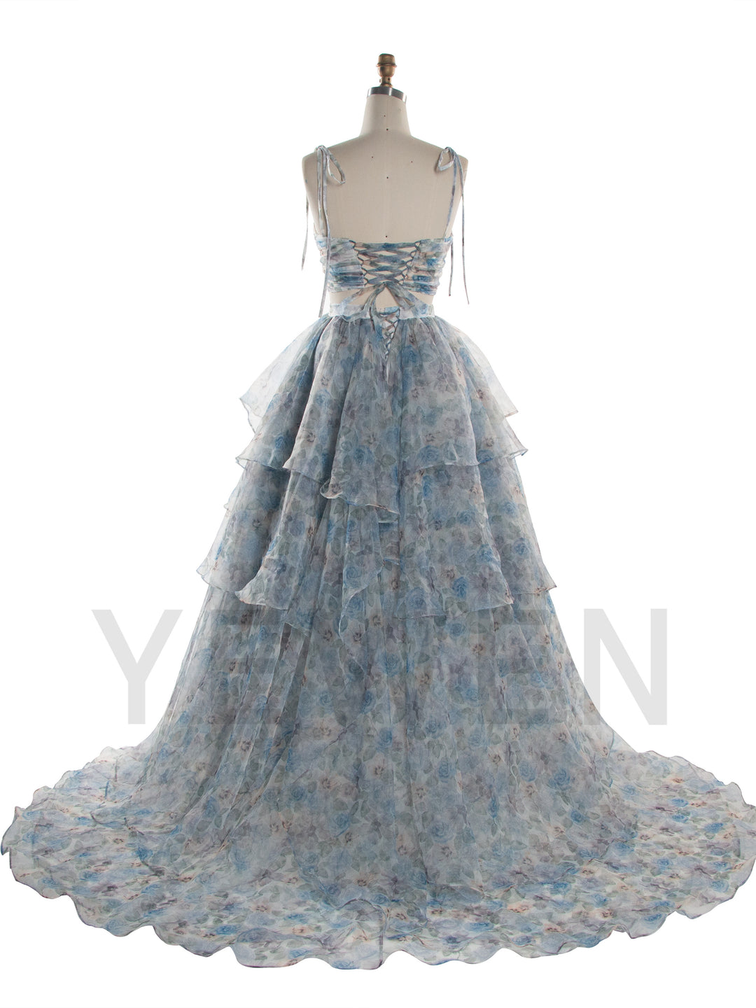 A light blue and white floral tiered gown displayed on a dress form mannequin against a white background.