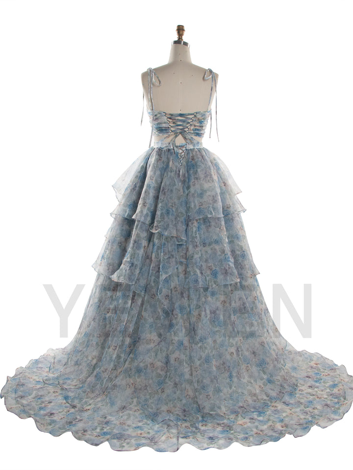 A light blue and white floral tiered gown displayed on a dress form mannequin against a white background.