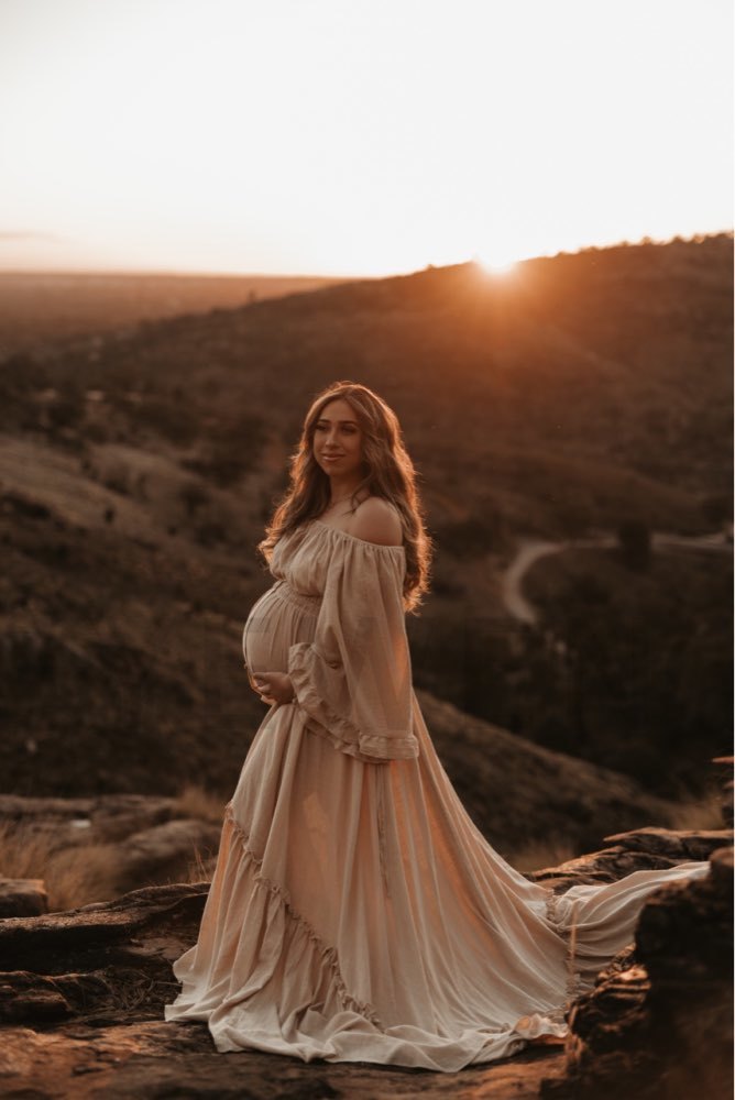 Flowing boho photoshoot dress with flare sleeves captured in motion during pregnancy photography