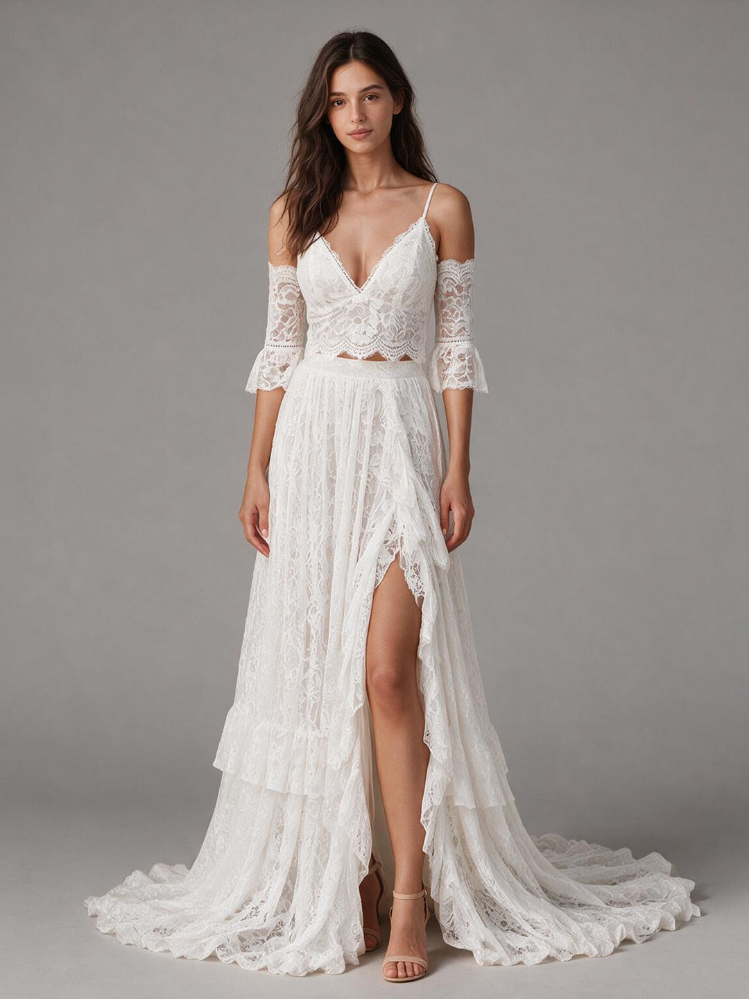 Front view of a boho wedding dress with a lace high slit skirt and spaghetti straps.