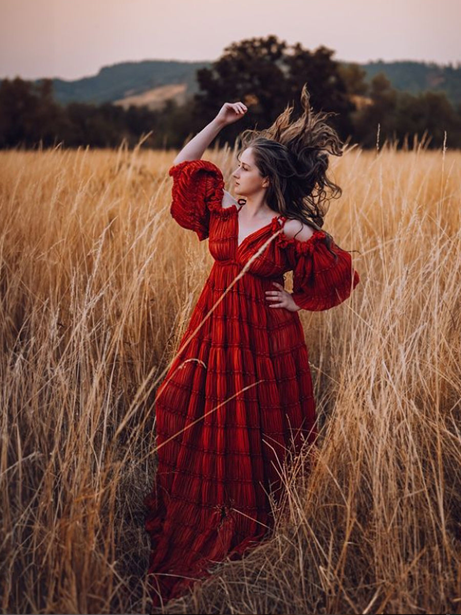 Flowing chiffon maternity photoshoot dress captured in motion showing elegant side slit movement