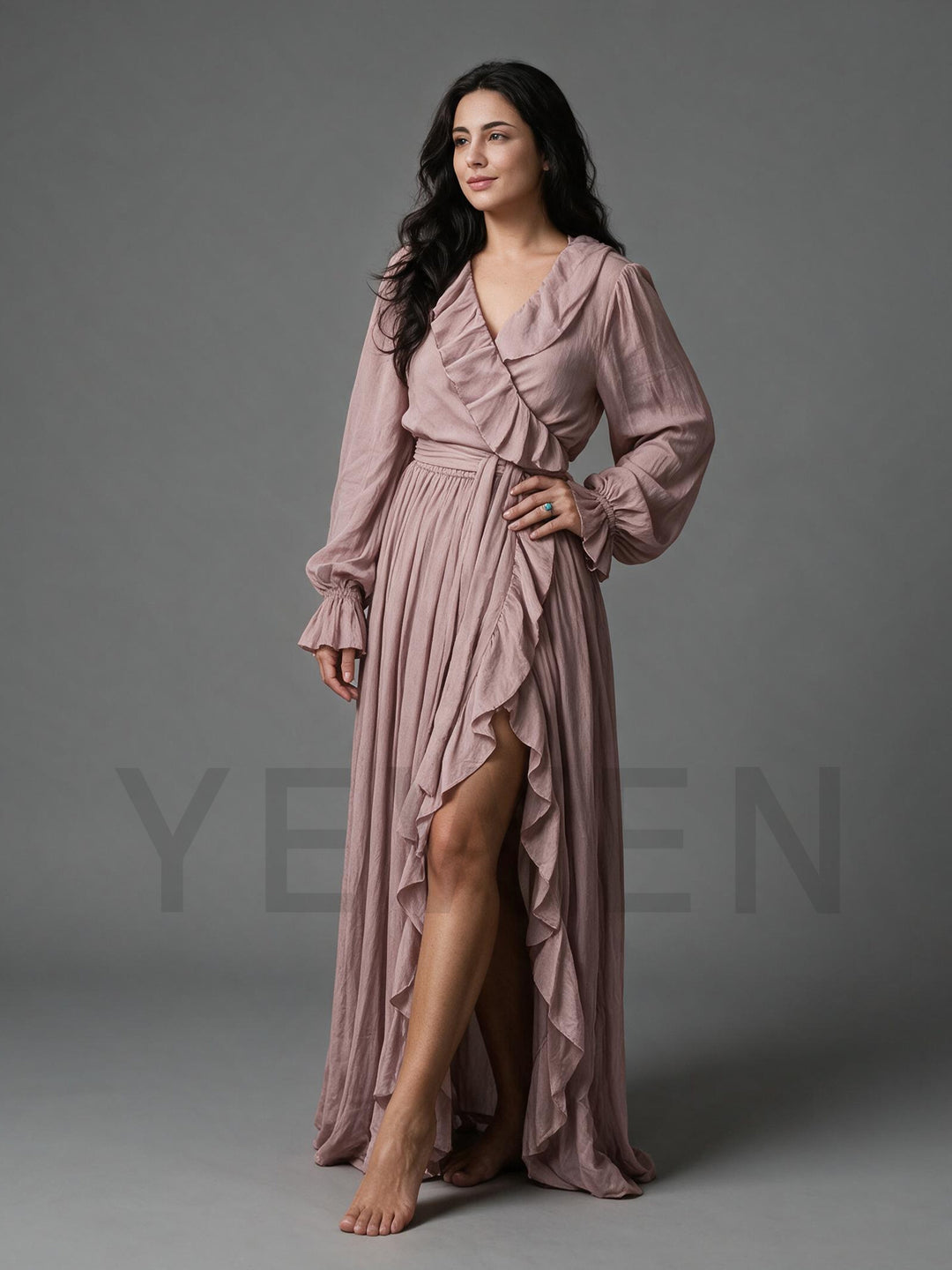 Side profile of a dusty rose cotton linen maxi dress showing the high side slit and sash belt.