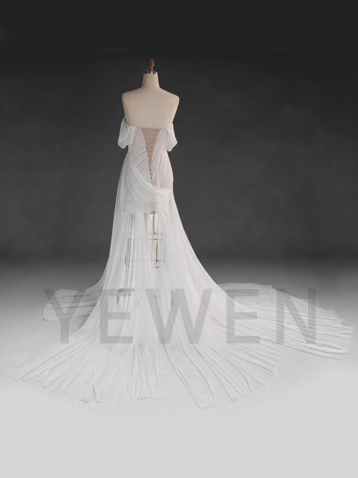 Back view of a white corset bridal gown, showing the lace-up back design.