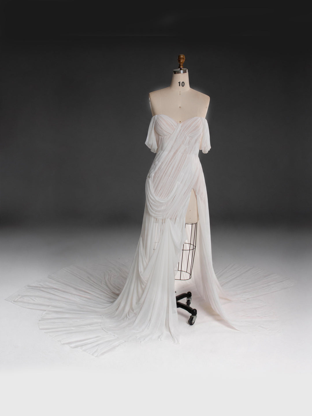 White draped off-shoulder corset bridal gown for wedding, front view.