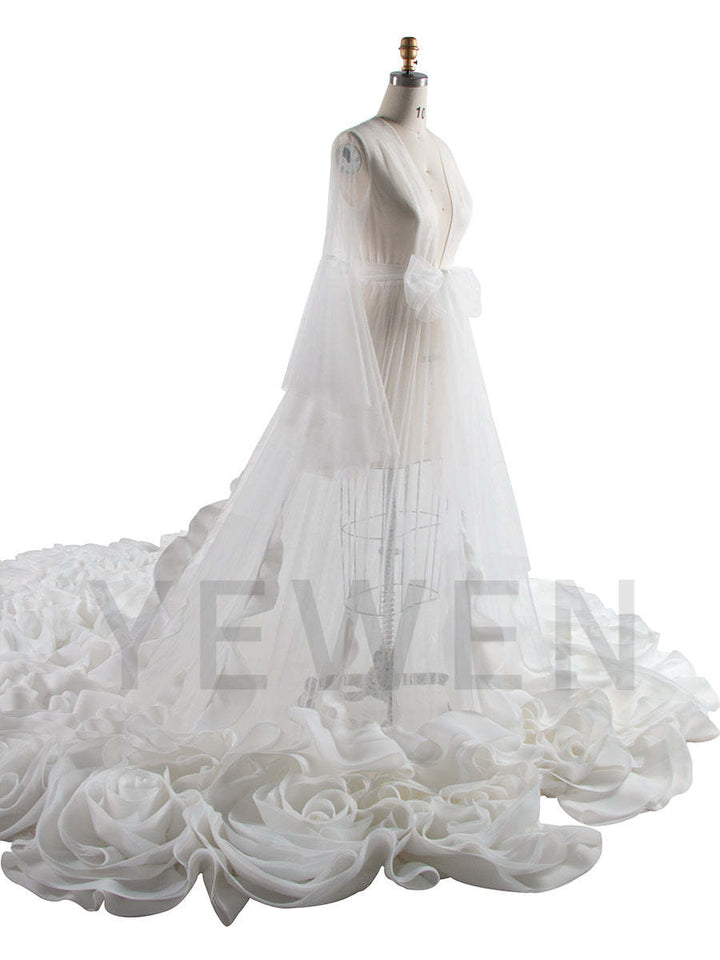 Side view of flower photo shoot dress showing long train and flowing organza ruffles for elegant photography