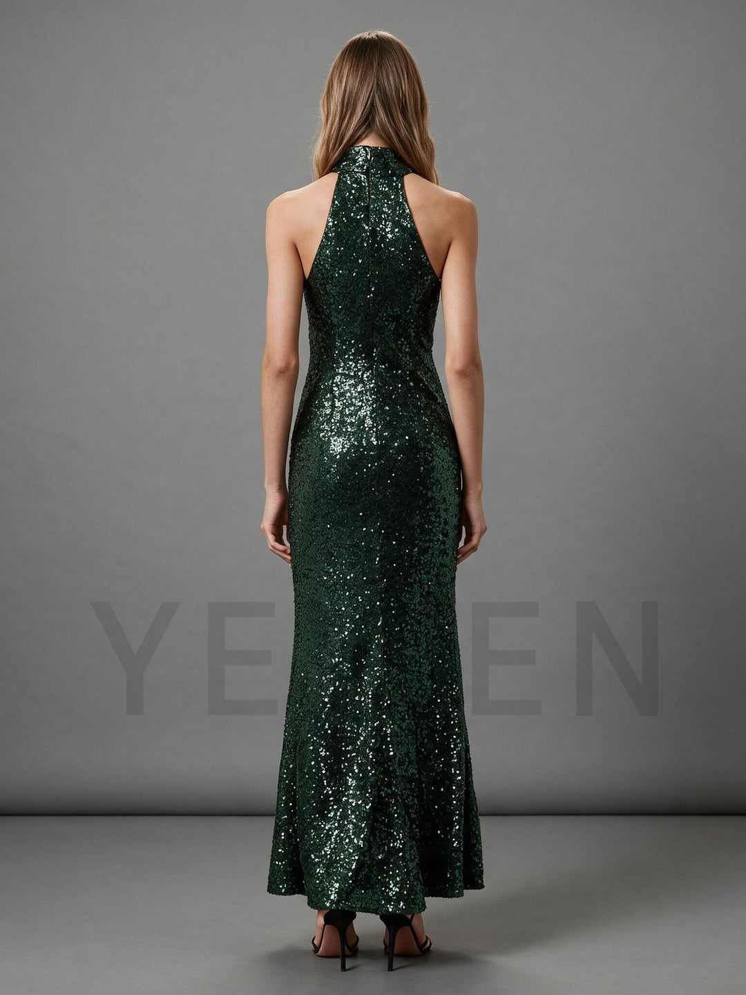 Back view of a green sequin halter maxi dress, showing the fitted silhouette.