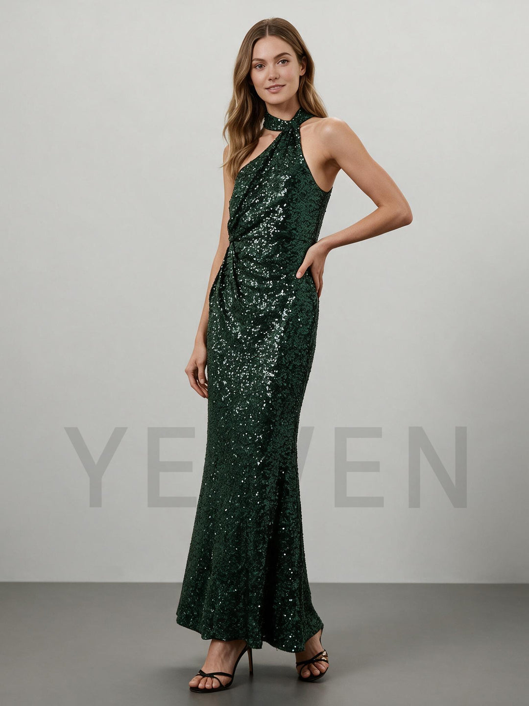 Side profile of a green sequin maxi dress for Christmas with a one-shoulder halter neck.