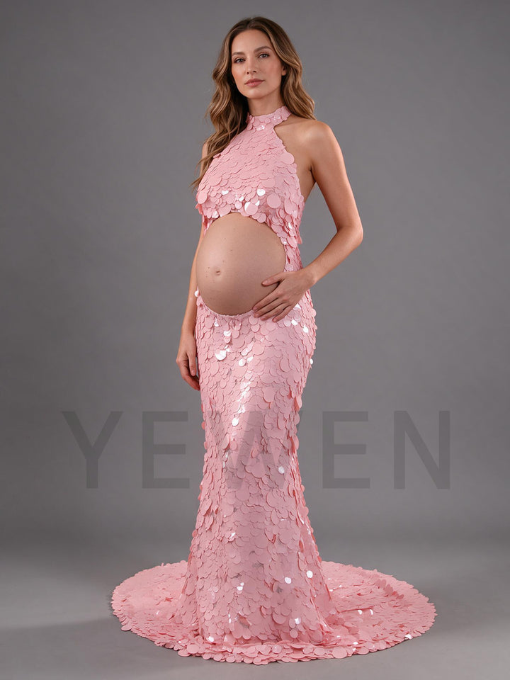 Side profile of a picture pink sequin maternity gown with a cutout belly.