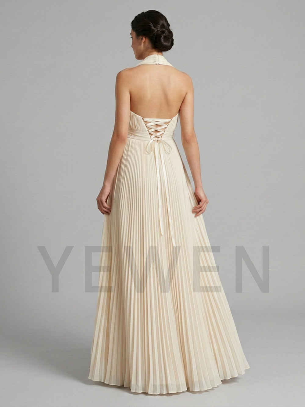 Back view of a pregnant model wearing a flowing halter neck maternity baby shower dress with adjustable lace-up back.