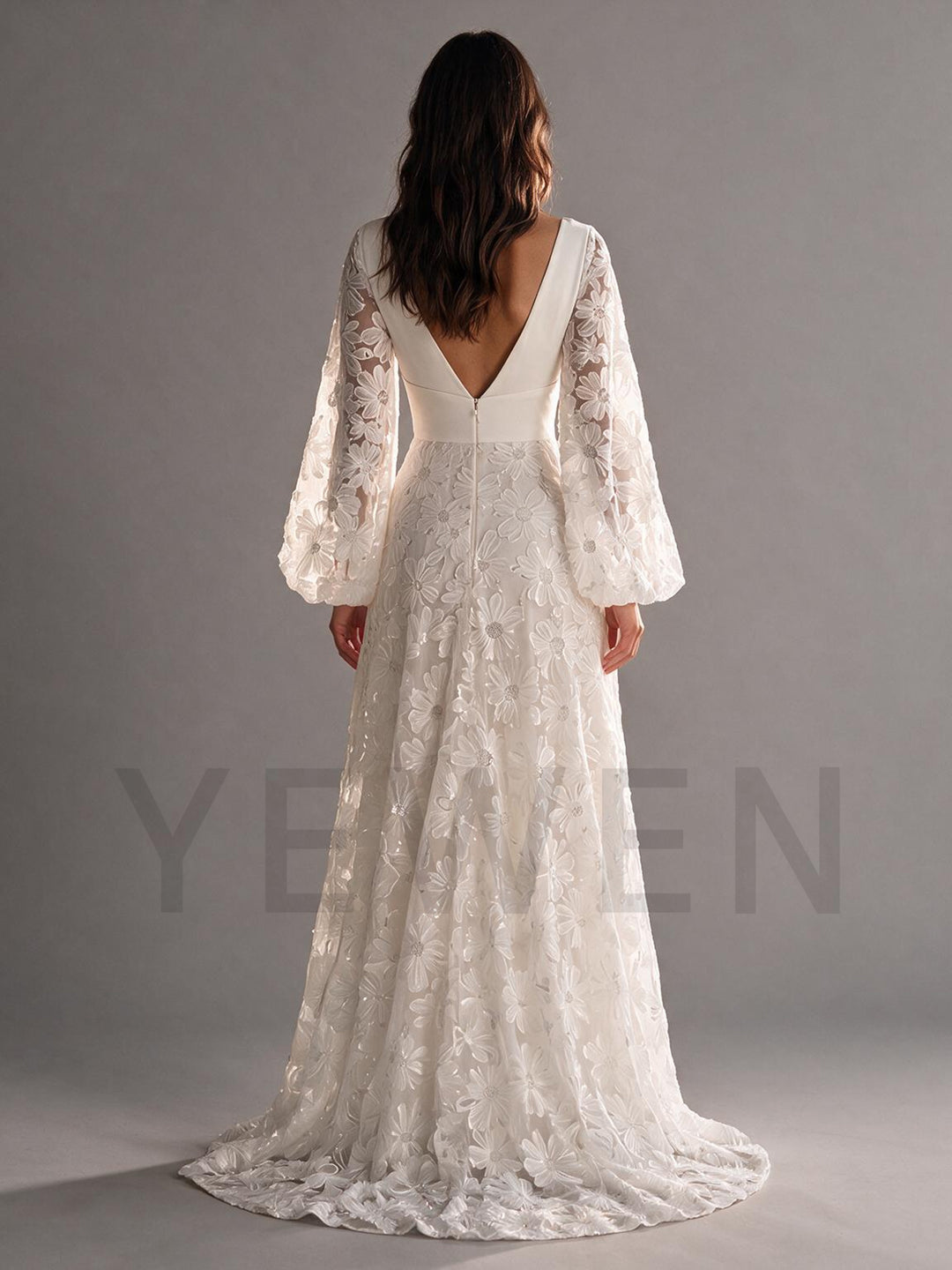 Side profile of a flowing ivory floral lace boho wedding dress with an A-line skirt.