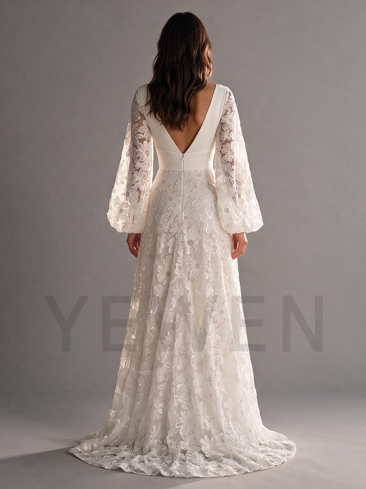Side profile of a flowing ivory floral lace boho wedding dress with an A-line skirt.
