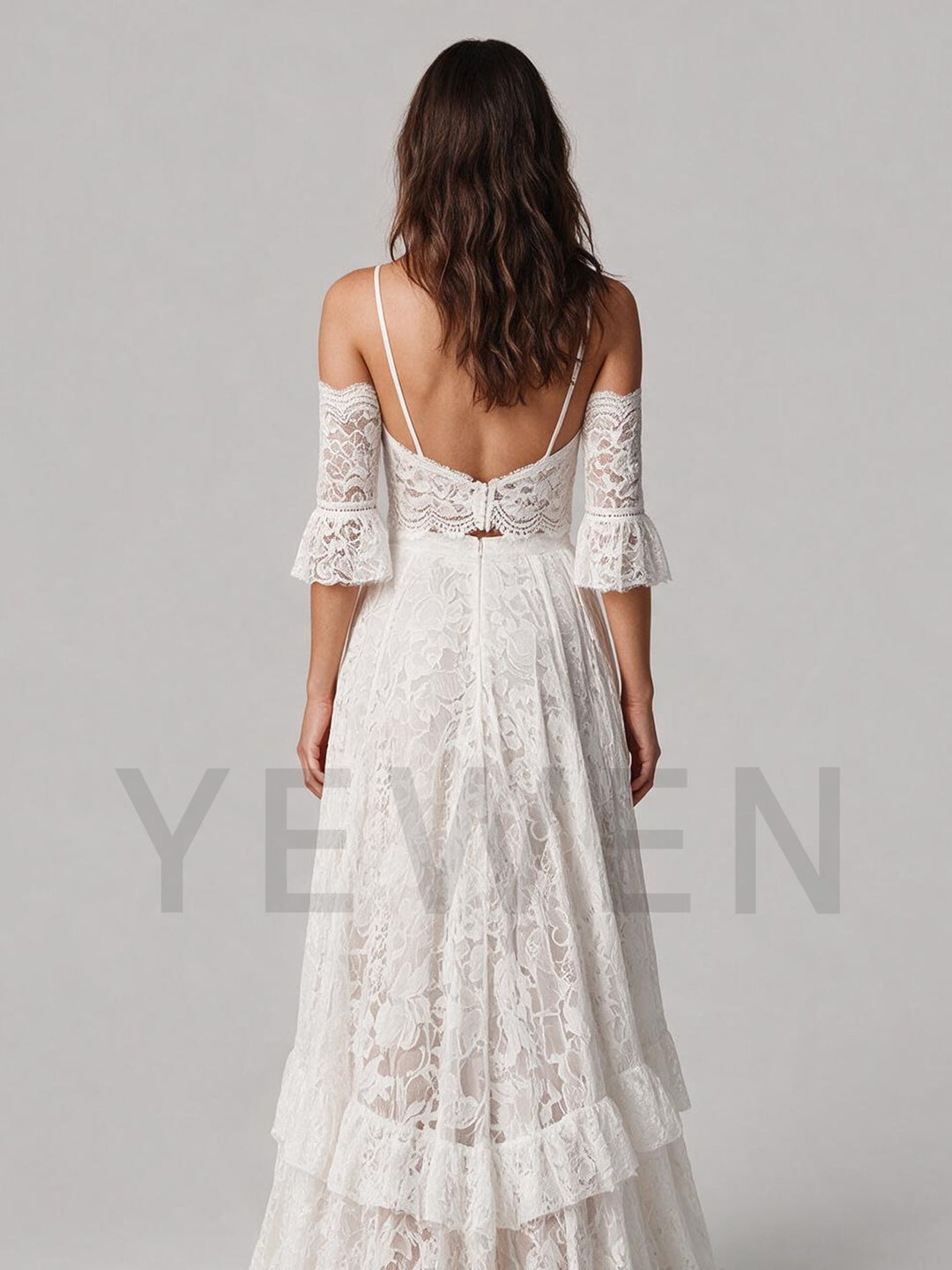 Back view of an ivory lace boho wedding dress featuring delicate buttons and an open back.
