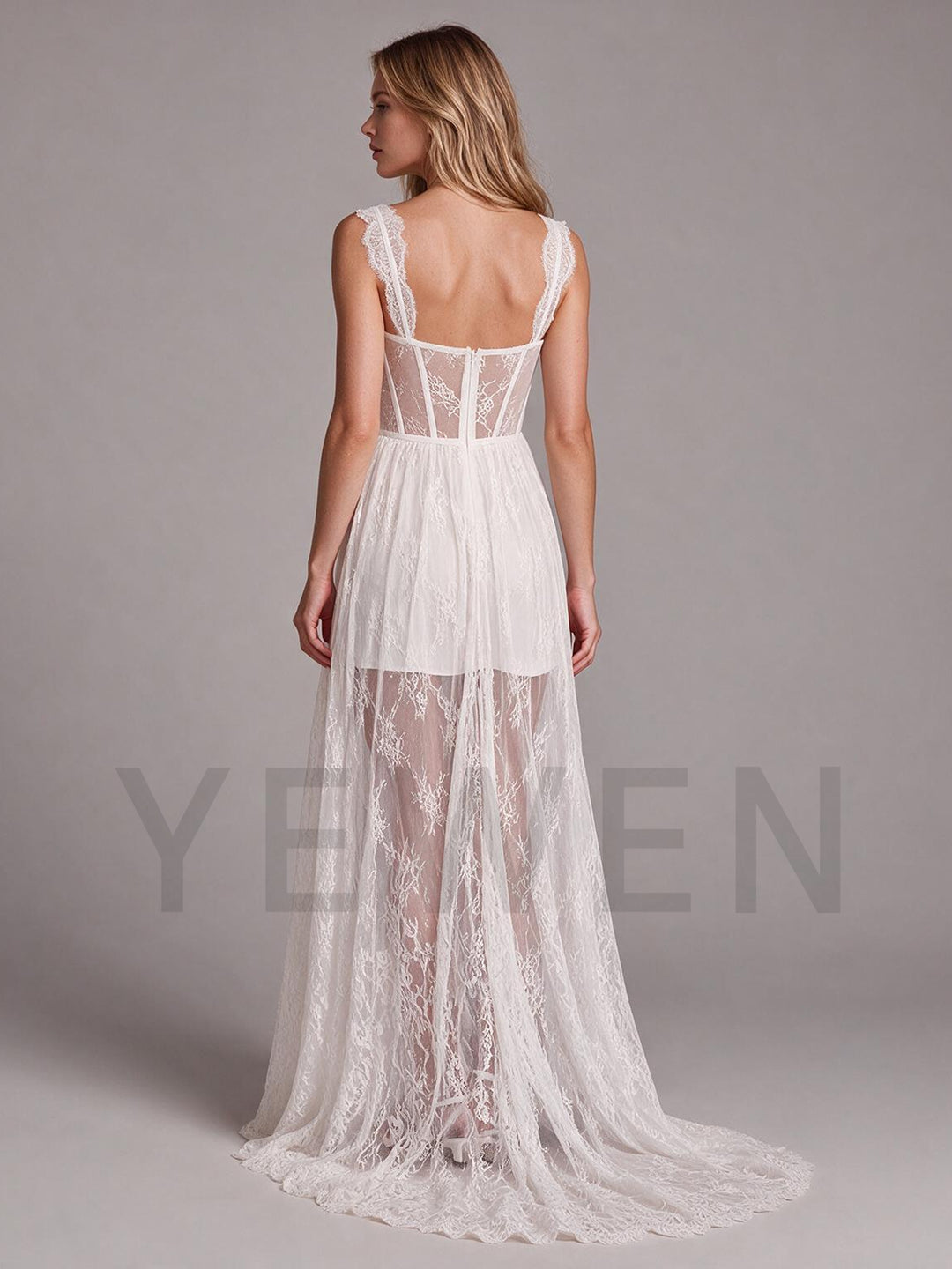 Back view of an ivory lace boho wedding dress with a corset bodice and sheer skirt.