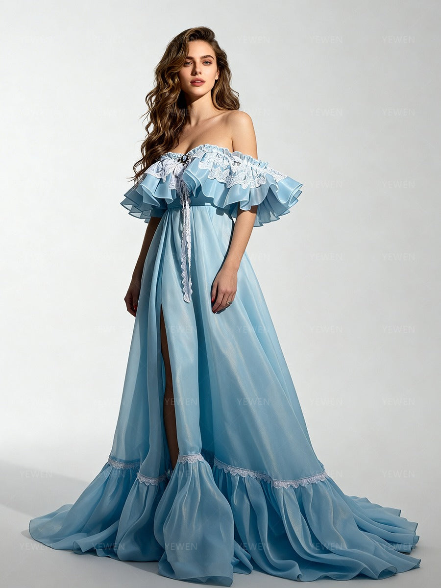 Side view of a model wearing a light blue off-shoulder ruffle high slit long dress for photoshoot party.