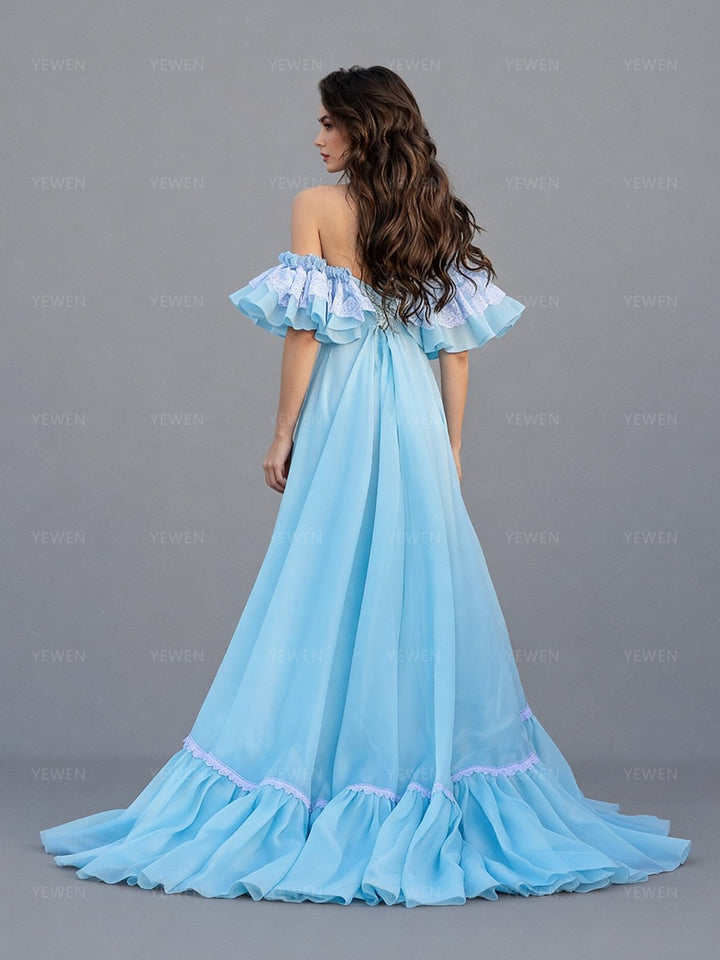 Back view of a model wearing a light blue off-shoulder ruffle high slit long dress for photoshoot party.