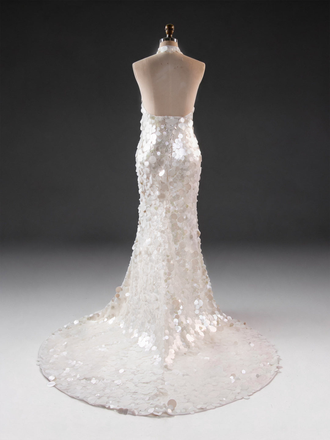 Back view of an ivory sequin maternity baby shower gown, showing the halter neck design.