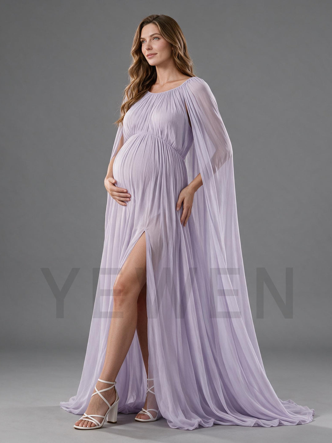 Side view of an elegant lavender chiffon maternity photoshoot gown with a high slit and flowing cape.