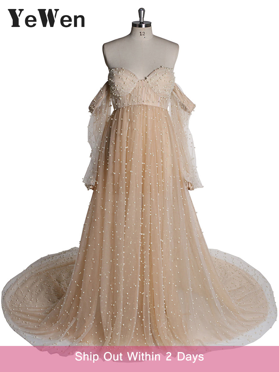 Real full body shot of ivory maternity photoshoot gown with pearl details in natural light setting