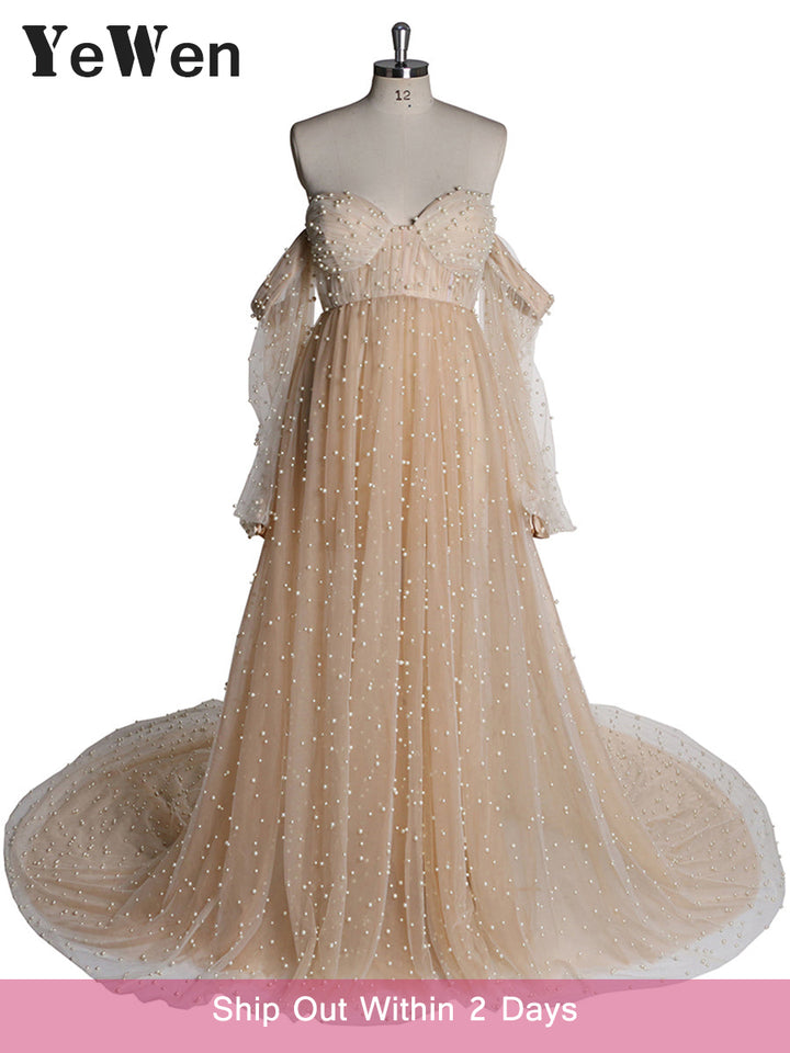 Real full body shot of ivory maternity photoshoot gown with pearl details in natural light setting