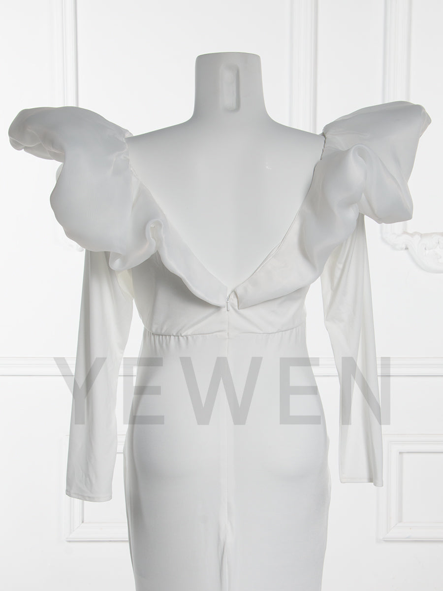 Close-up back view of a maternity wedding gown highlighting the ruffle sleeve and bow details on a mannequin.
