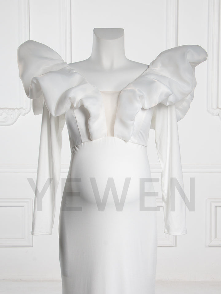 Close-up front view of a maternity wedding gown highlighting the V-neckline and bow shoulder details on a mannequin.