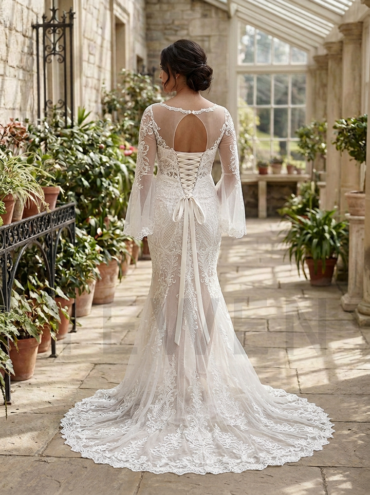 A woman viewed from behind wearing a white lace bridal gown with long sheer sleeves, an open lace-up back, and a full train, standing in a sunlit stone conservatory with potted plants.