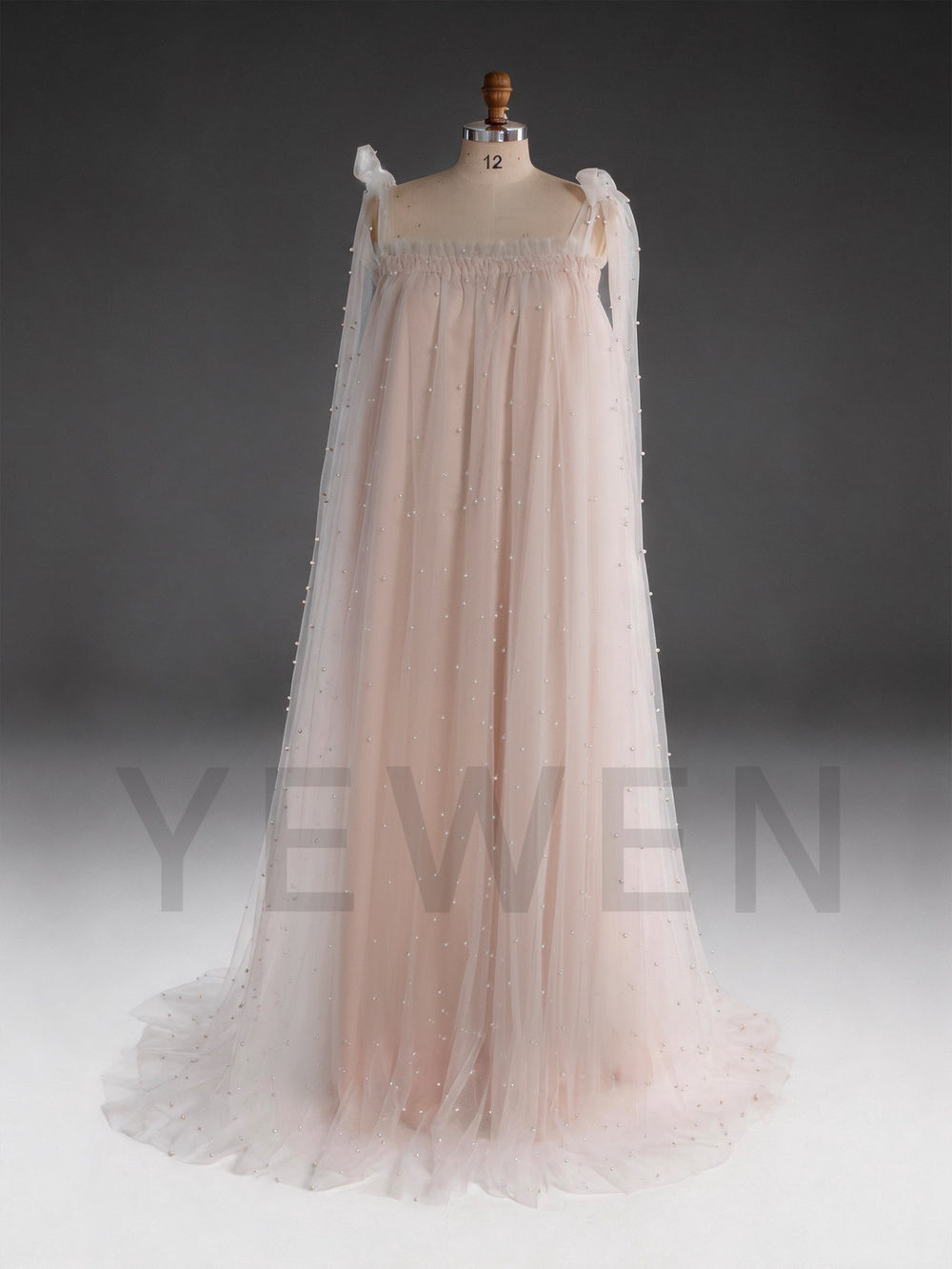 Front view of a blush pink sheer cape pearl tulle dress for women.