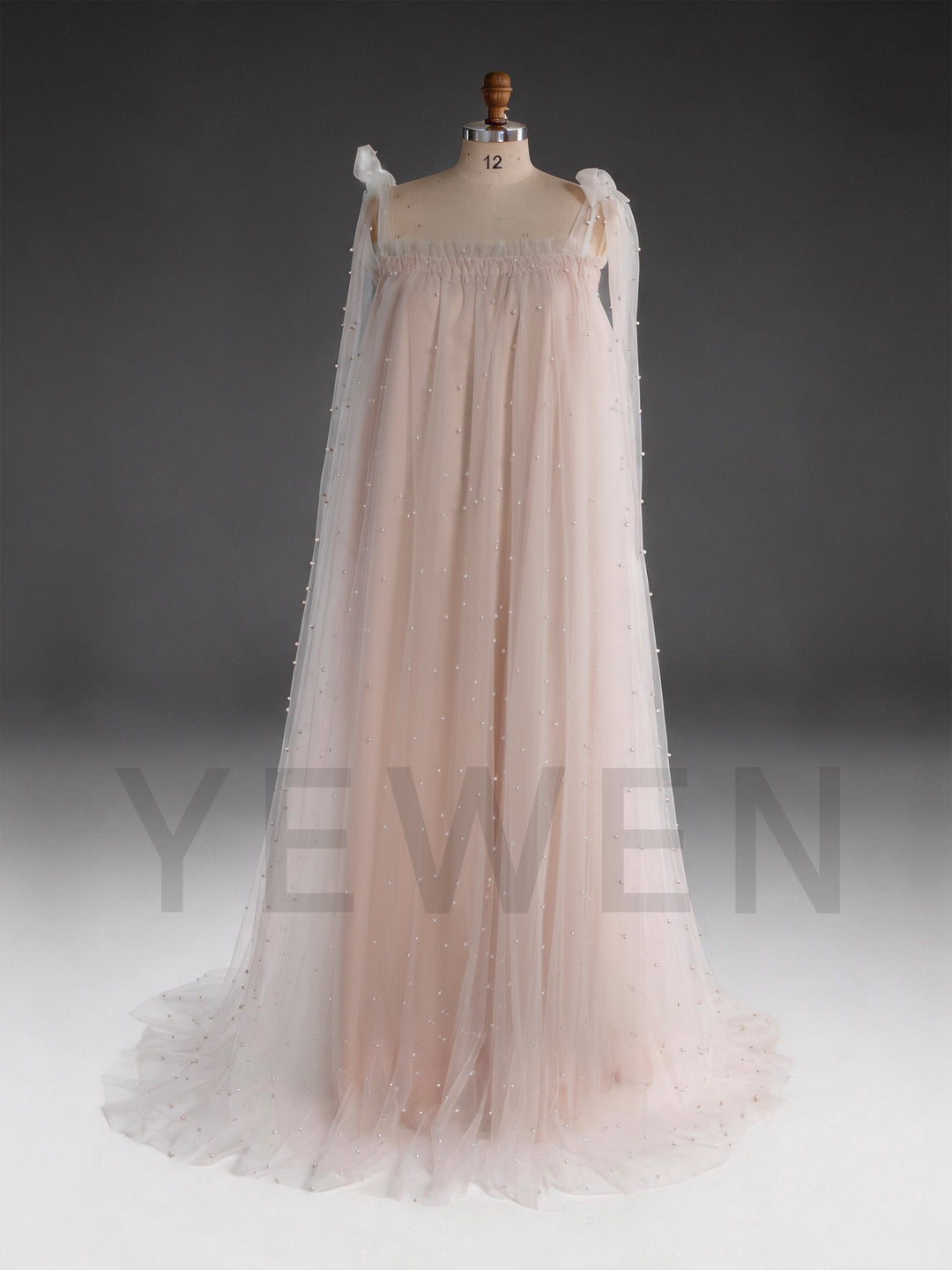Front view of a blush pink sheer cape pearl tulle dress for women.