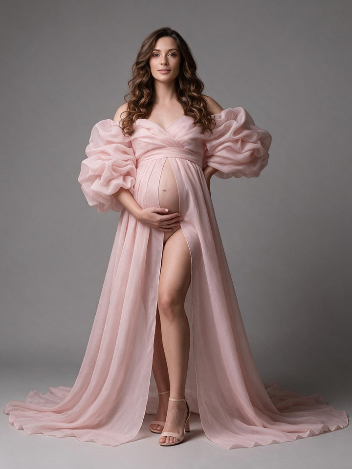 Blush pink organza maternity photoshoot gown with puff sleeves and a high slit, front view.