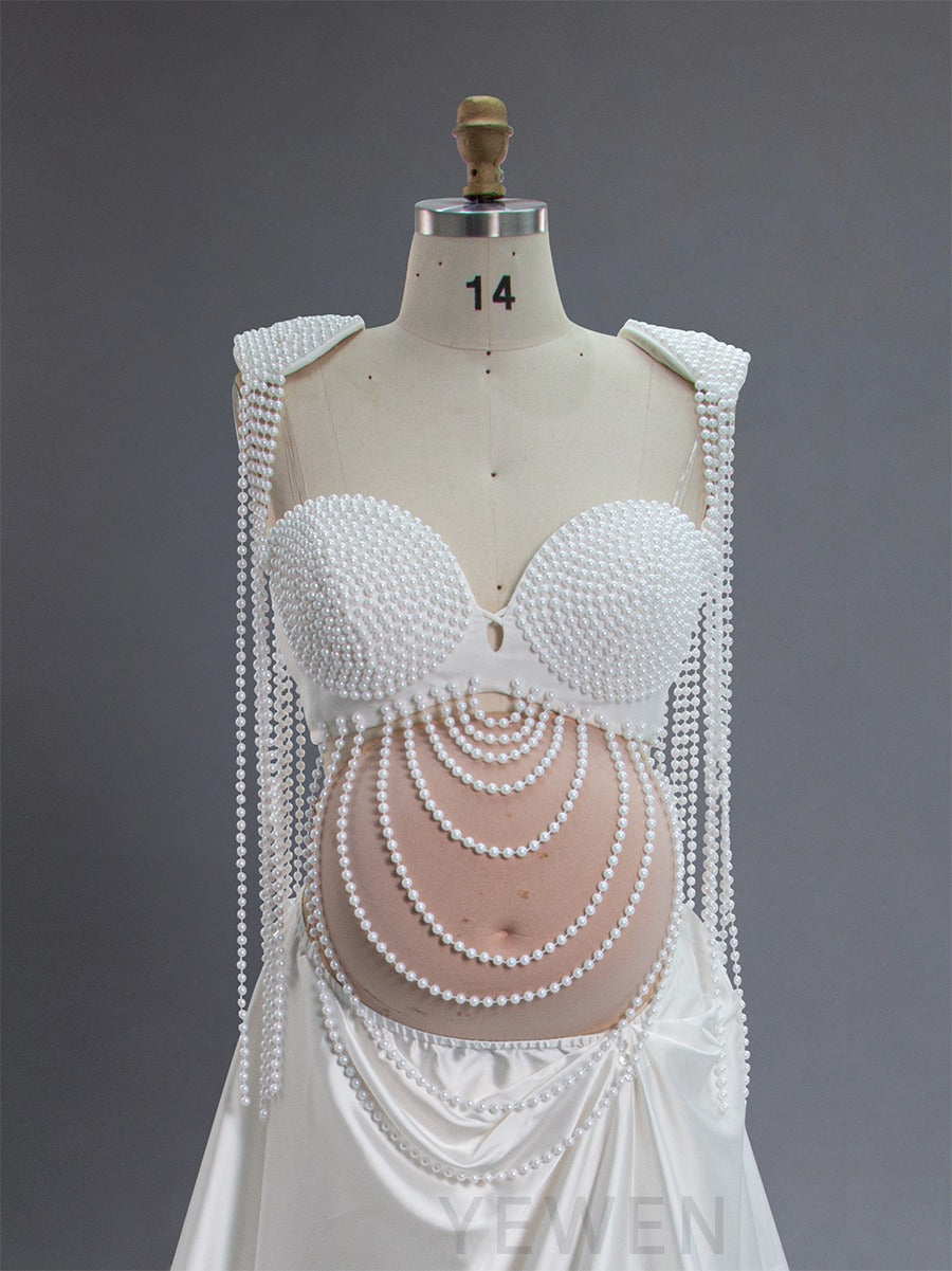 Close-up of handmade pearl detailing on maternity photoshoot dress
