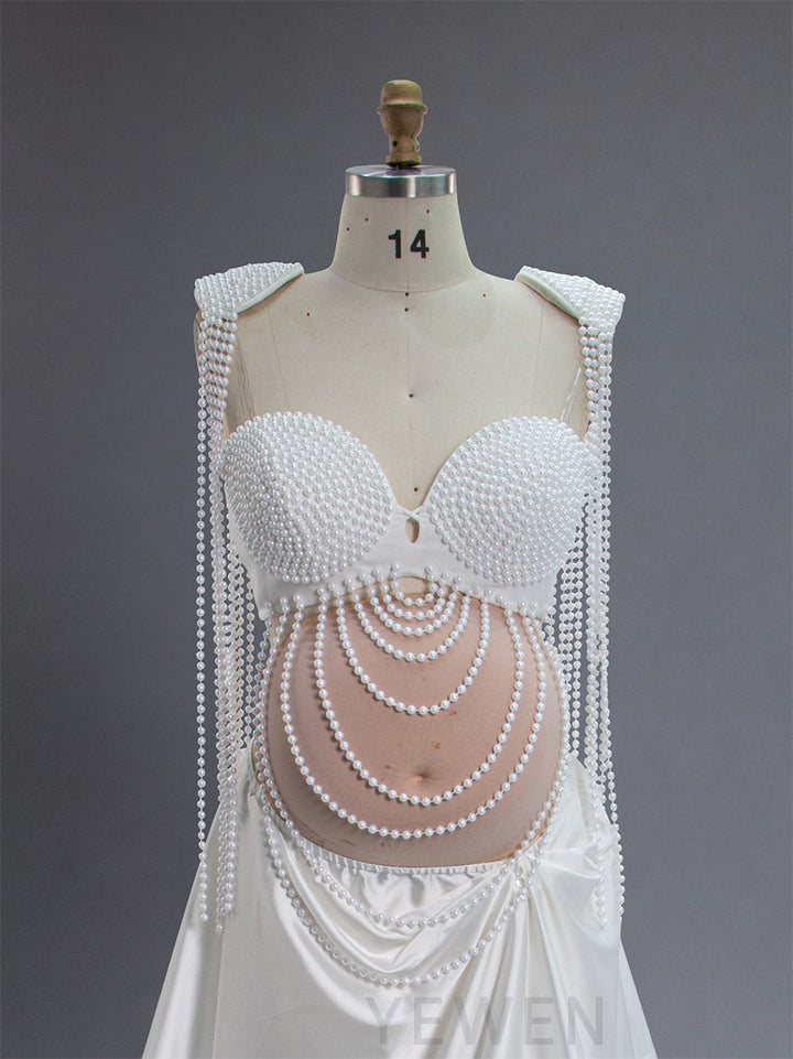 Close-up of handmade pearl detailing on maternity photoshoot dress