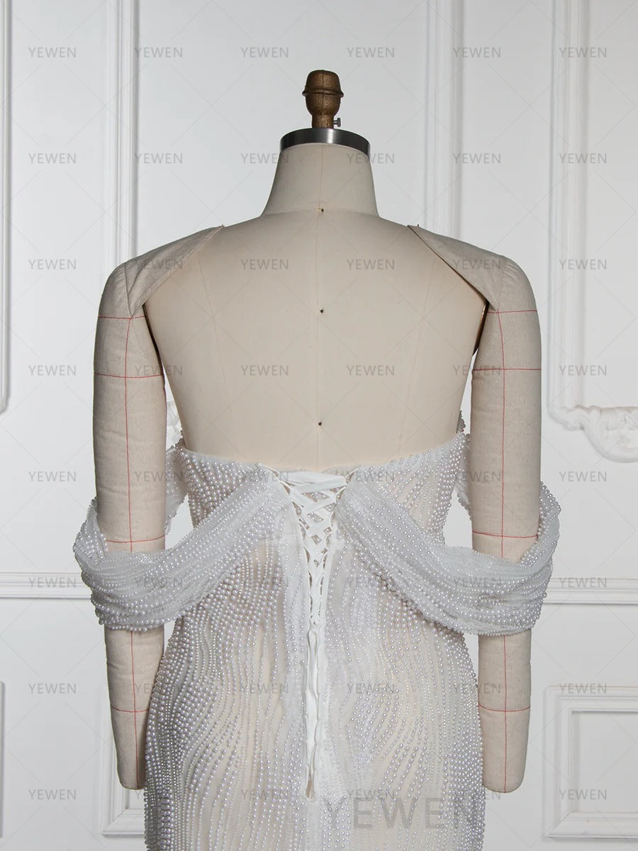 Back view of elegant pearl maternity gown designed for professional photography and baby shower photoshoots