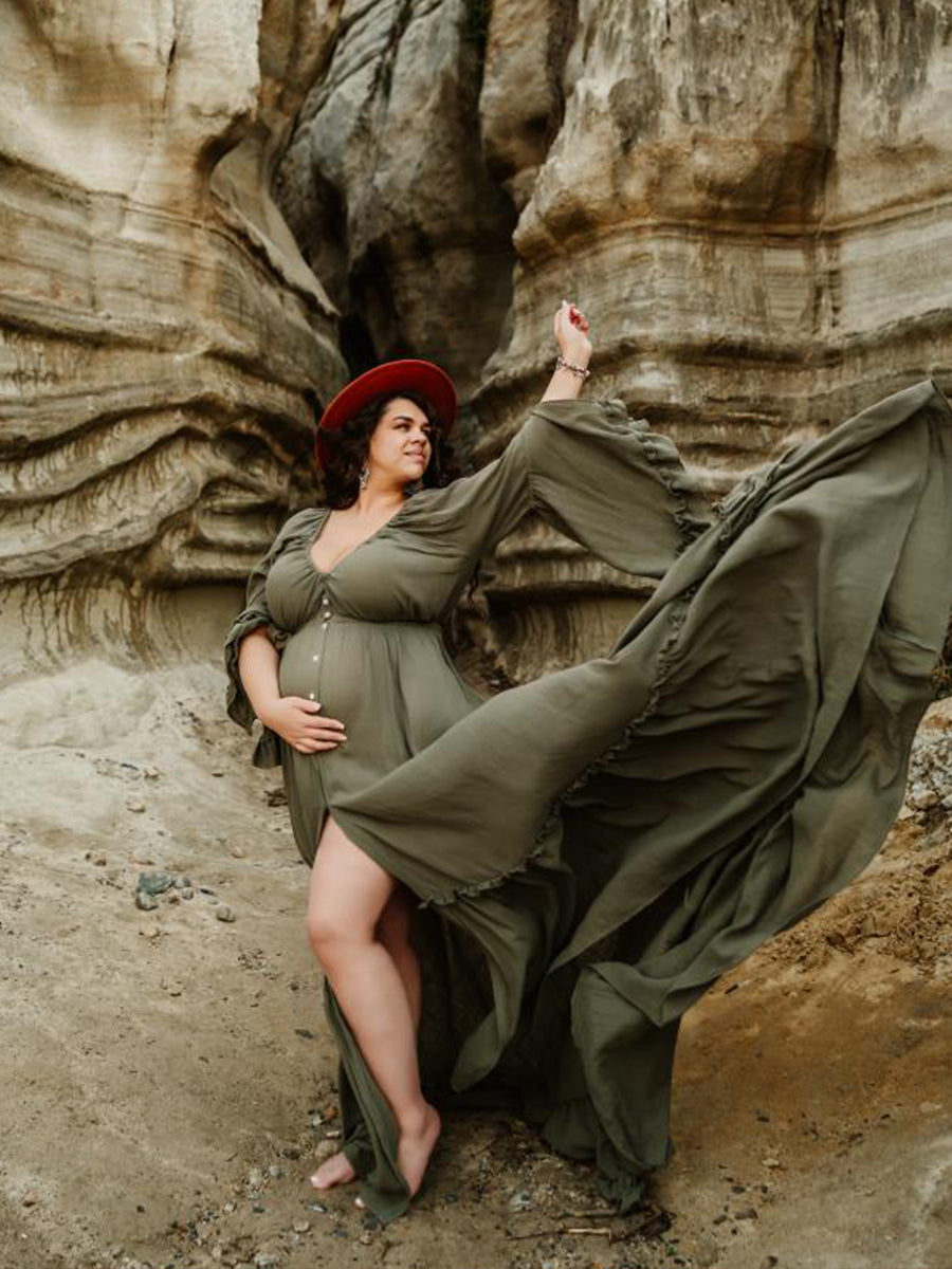 Flowing photography dress captured in motion during elegant maternity photoshoot