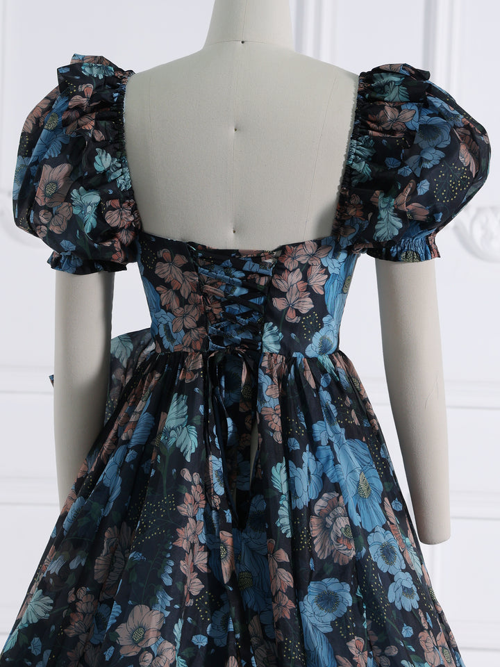 Close-up back detail of photoshoot dress highlighting flowing train and elegant organza craftsmanship