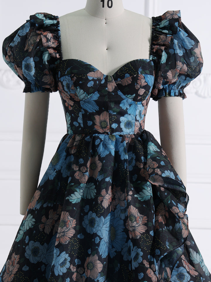 Close-up front detail of photoshoot dress showing silk organza texture and colorful floral print details