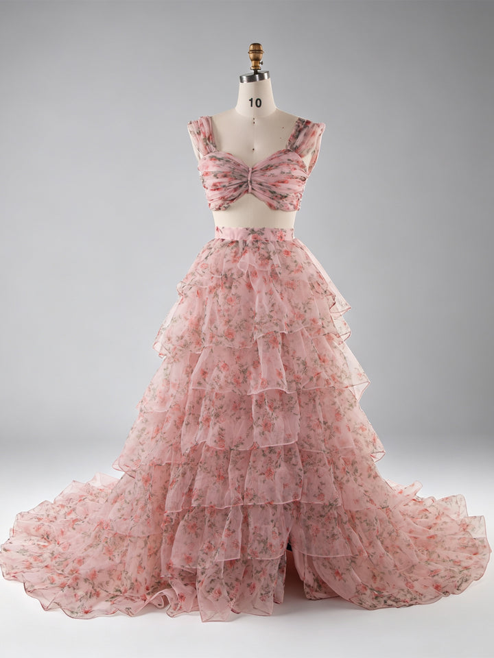 A pink floral two-piece dress displayed on a mannequin against a light gray studio background. The set includes a cropped, ruffled top with a sweetheart neckline and a layered tulle skirt with a matching floral print.