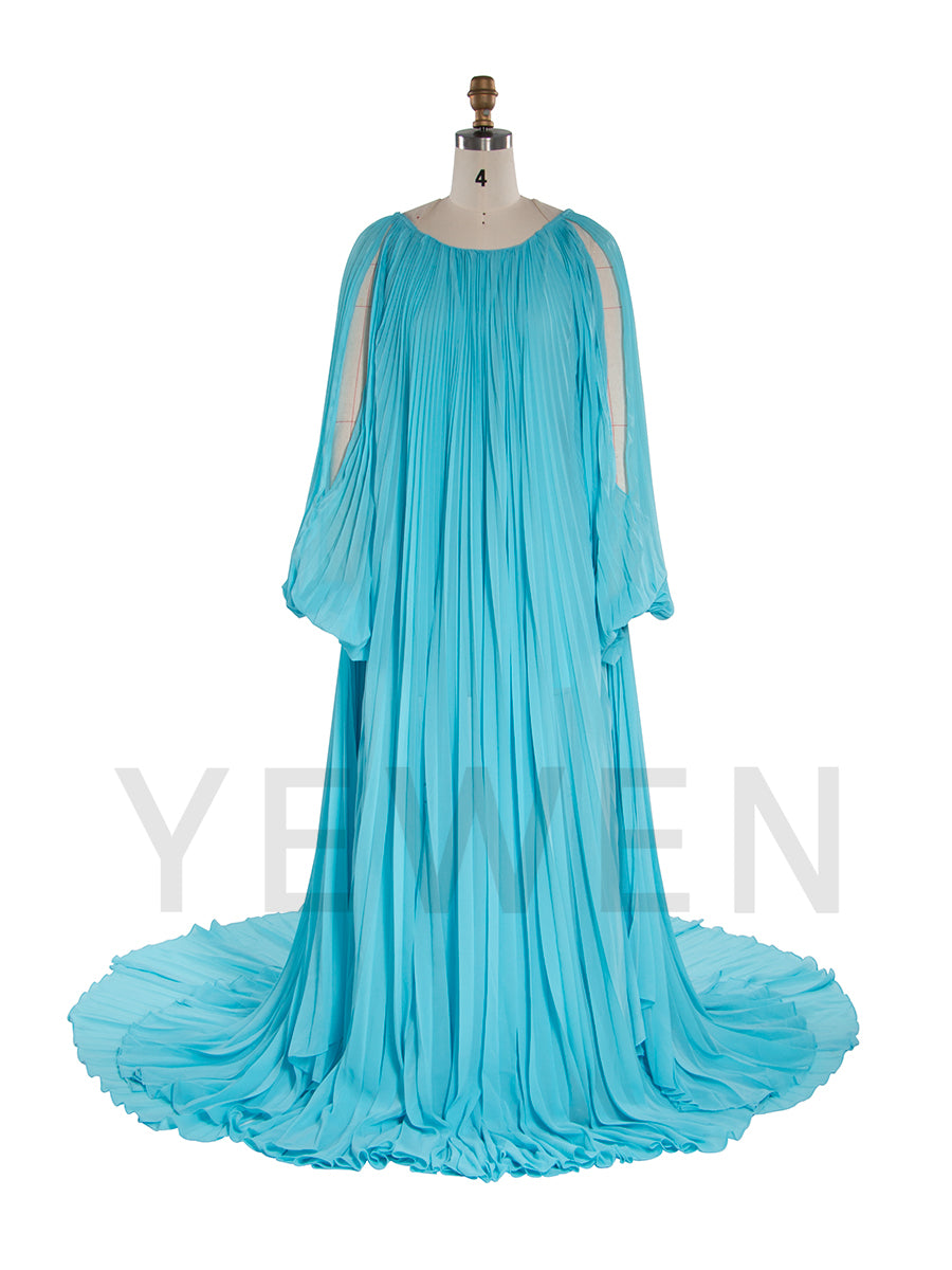 Front view of pleated blue maternity photoshoot dress featuring off shoulder design and elegant flowing silhouette