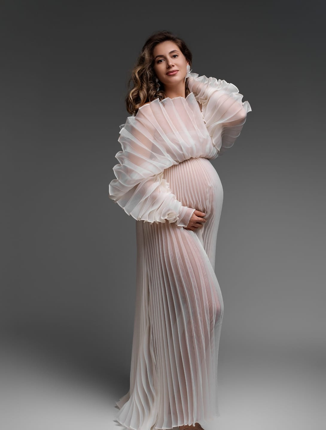 Elegant organza pleated maternity photoshoot dress designed for luxury pregnancy photography and baby shower sessions